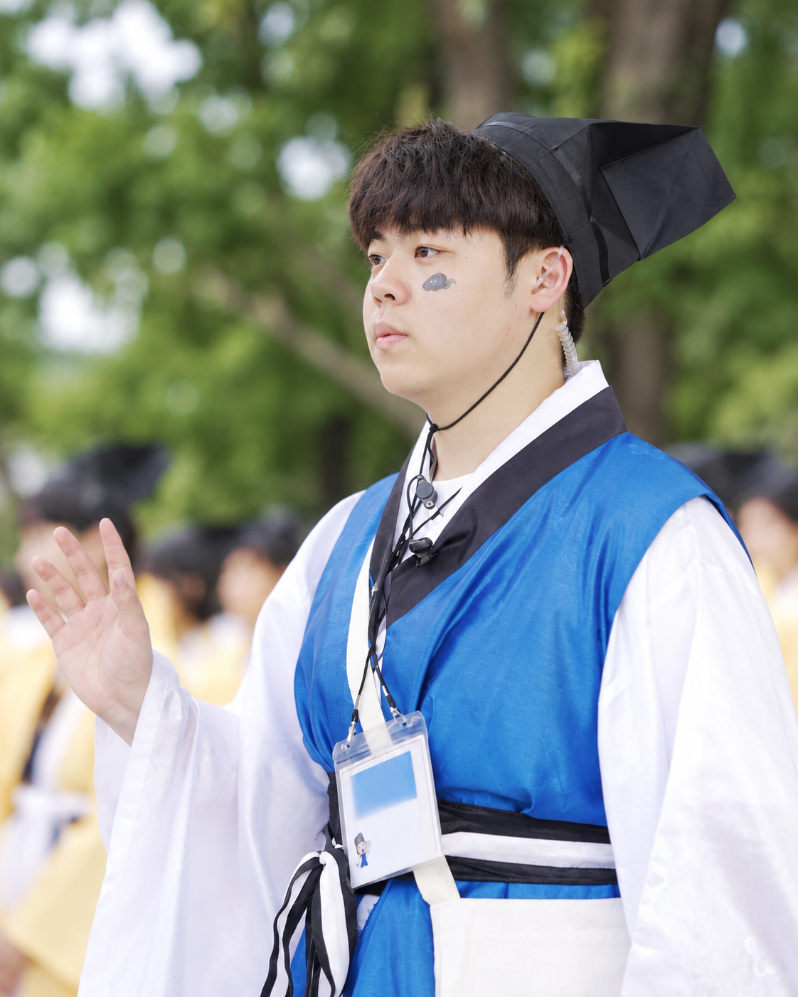 청랑 복장을 입은 양서준 님이 행사 현장에서 손을 들어 인사하는 모습